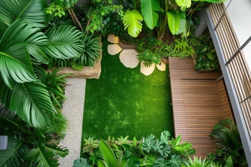 Gordijnen high view of a contemporary Australian home or residential buildings front yard features artificial grass lawn turf, timber edging and many tropical plants © Kien