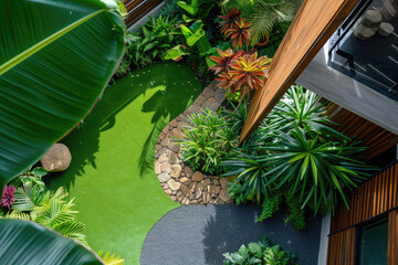 high view of a contemporary Australian home or residential buildings front yard features artificial grass lawn turf, timber edging and many tropical plants