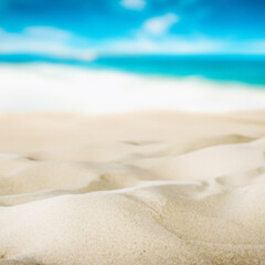 Fototapeta na wymiar Closeup of beach sand with blue sky and white clouds background.