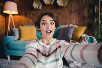 Photo of cheerful astonished girl open mouth make selfie unbelievable news loft interior flat...