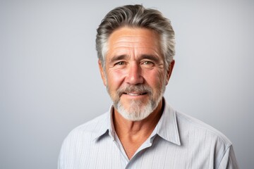 Handsome middle aged man with grey beard and mustache on grey background