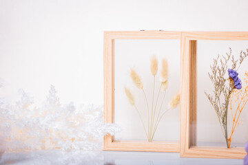 Encased in glass within a wooden frame, vibrant blooms bloom against a bright background, exuding a boho charm.