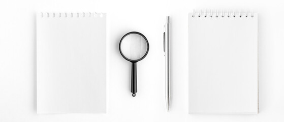 Spiral Notepad and Notepad Page with Pen and Magnifying Glass.