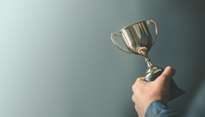 business man holding a trophy from his success. Business reward for your effort for success in your...