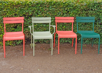 Four Colorful plastic chairs in the park - 729940568