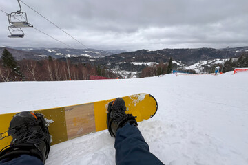 A Snowboarder Journey Through the Snowy Mountains. Snowboarder view of the slope and the mountains...