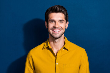 Photo portrait of handsome young guy cheerful toothy smile wear trendy yellow outfit isolated on dark blue color background