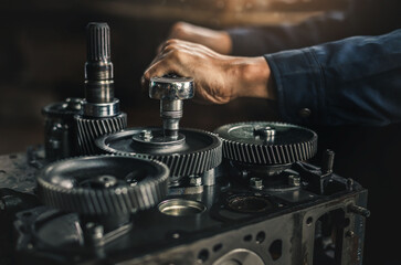 Car spare parts.The cylinder head of an internal combustion engine. Close-up of the mechanic's hands. Product control. Installation of condensers. Preparation for installation. Repair and maintenance.
