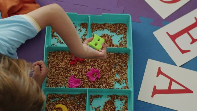 Office of fun: kid, speech therapist in white coat, dive into language games, laughter, learning. Education shines.