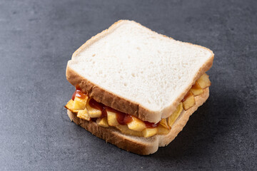 Sliced white bread on black slate background