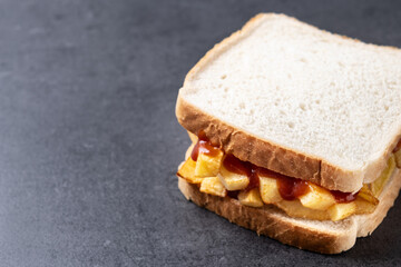 Sliced white bread on black slate background. Copy space