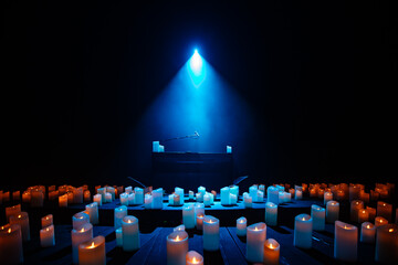 piano on stage with lots of candles