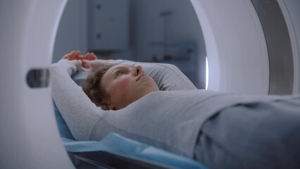 Close up shot of patient lying on CT, PET, or MRI machine bed. Advanced tools scan body and brain for detailed examination in medical facility. High-tech modern medical laboratory. Healthcare concept.