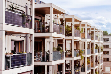 Modern Facade of Multifamily Building with Mini Solar Panel Energy System or Small Photovoltaic...