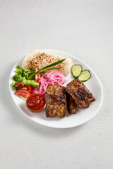 Barbecue pork ribs with fresh vegetable garnish and flatbread, perfect for grill menus and culinary blogs