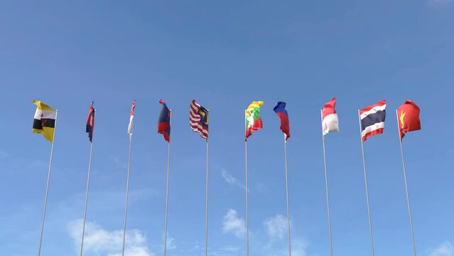 Looping video of ASEAN flag Waving on blue sky background, Loop Animation Asia nation flags