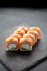 Baked Philadelphia sushi rolls with spicy sauce, offering a creamy and tangy taste in each bite