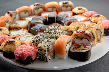 Classic and baked sushi rolls assortment; Philadelphia rolls topped with spicy sauce, a mix of warmth and tradition