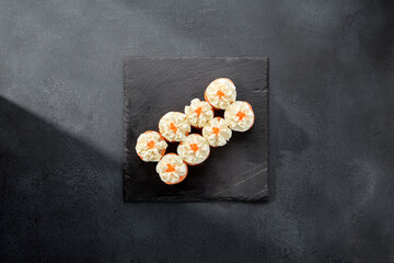 Deluxe Philadelphia rolls wrapped in salmon and topped with a dollop of cream cheese, a luxurious...