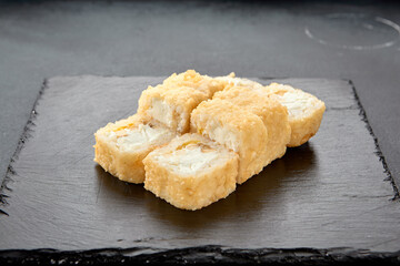Tempura roll with chicken and cream cheese; a warm fusion roll combining crispy tempura batter with...