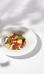 Roast Beef Salad with Quail Eggs and Vegetables on Shadowed White Presentation