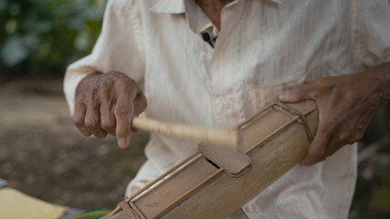 Playing handmade instrument 