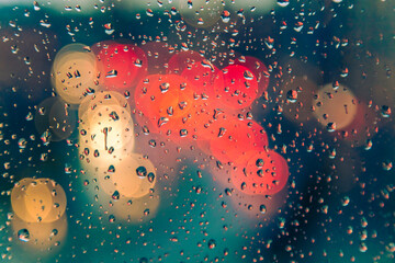 rain drops on the window with traffic bokeh background