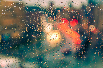 rain drops on the window surface and traffic bokeh background - 729963788