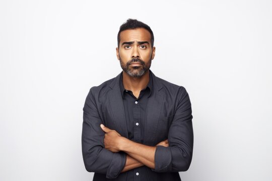 Portrait of young handsome bearded indian man in black shirt.