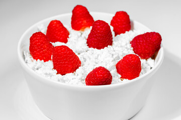 Cottage cheese with raspberry. Selective focus, horizontal. Bio organic natural ingredients. Healthy eating.