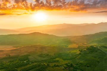 rustic landscape view of rural green valley in mountain hills with farms and gardens