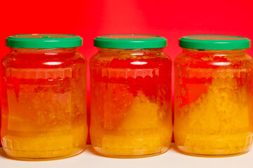 Jar of natural honey made at home on a table.