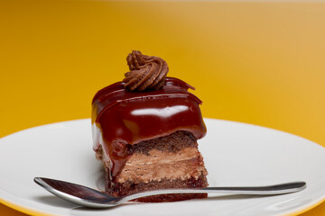 Amandina cake on a plate and a spoon.