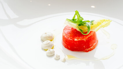 Close up of stuffed red beef carpaccio with rucola and endive salad leaves on a white background