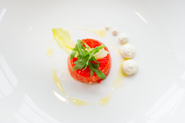 Top view of stuffed red beef carpaccio with rucola and endive salad leaves on a white background