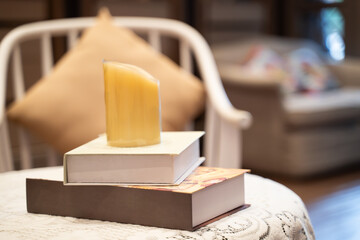 Candles placed on top of books in the living room of the house