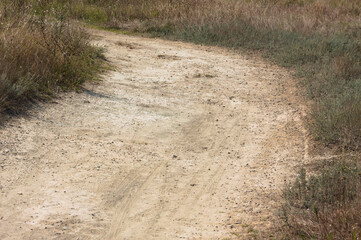 Closeup of dirt pathway with selective focus on foreground