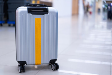 Stylish travel bag In an empty airport hall, the suitcases of vacation travelers