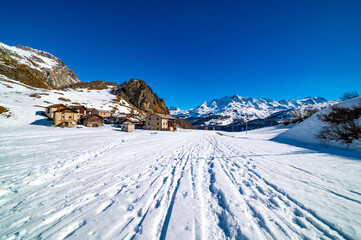 Fototapeta premium Panoramic view of the Engadine, Lake Sils, and the village Grevasalvas, in winter.