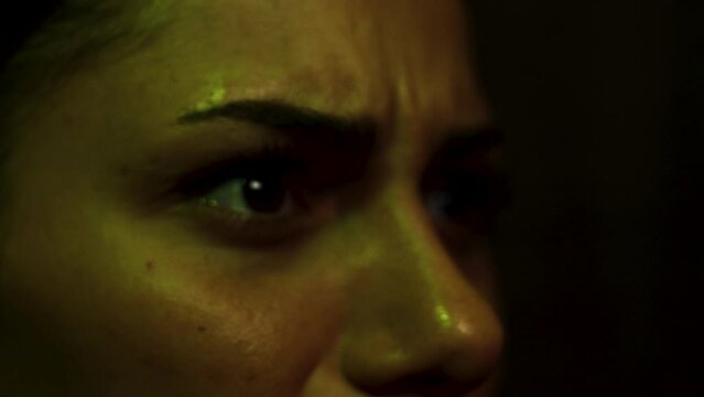 Close up on woman's eyes as she winces and flinches in disgust