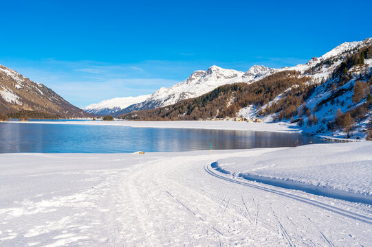 Engadine, Switzerland, Sils Maria lake, the village of Isola and the snowy landscape.
