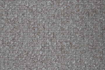 wide upholstered armchair with fabric upholstery on wooden legs in retro style, isolated on a white background