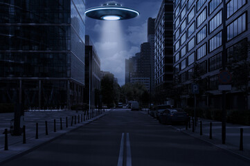 Alien spaceship emitting light over buildings in city. UFO, extraterrestrial visitors