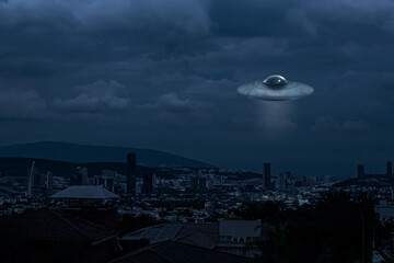 Alien spaceship flying over city in evening. UFO, extraterrestrial visitors