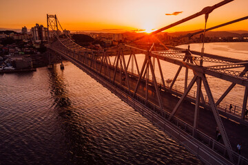 Hercilio luz cable bridge with sunset in Florianopolis, Brazil. Aerial view - obrazy, fototapety, plakaty