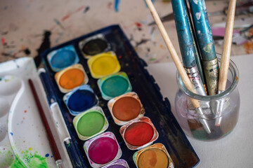painting lessons, canvas with paints, brushes and other elements for painting