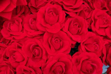 fabricated rose background and texture. red artificial rose.