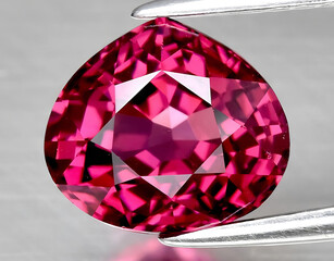 natural pink purple rhodolite garnet gem on the background