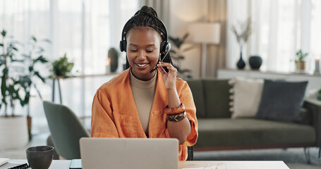 Black woman, headset in home office with laptop and phone call, remote work and crm in apartment. Virtual assistant at desk with computer, typing and conversation for advice, online chat and support - obrazy, fototapety, plakaty