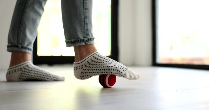 Myofascial release and massage of fascia of foot with ball. Myofascial relaxation of muscles of foot with massage ball at home closeup